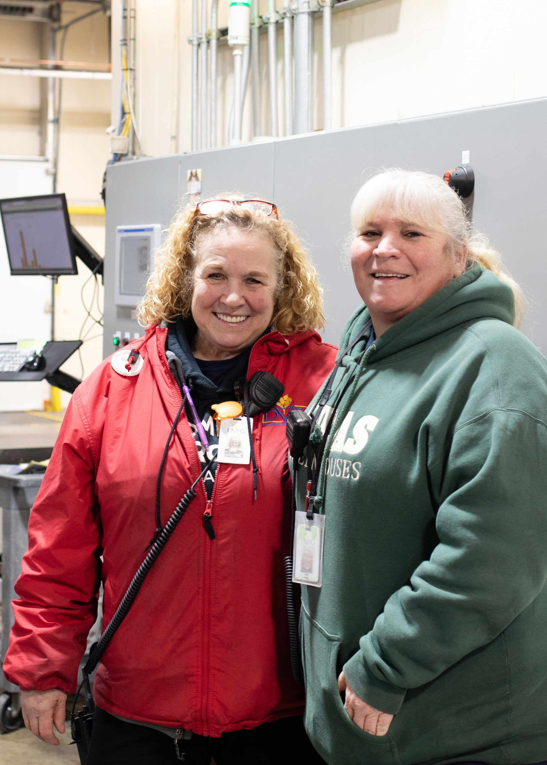 Two DVFlora employees posing in the warehouse.